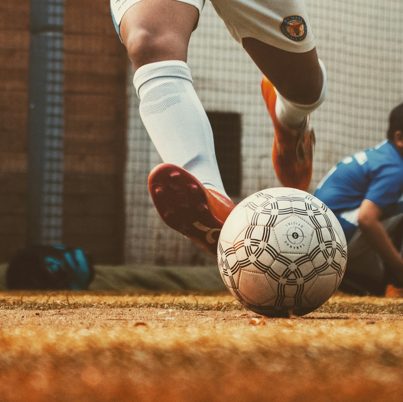Close-up of a soccer player striking the ball during a match