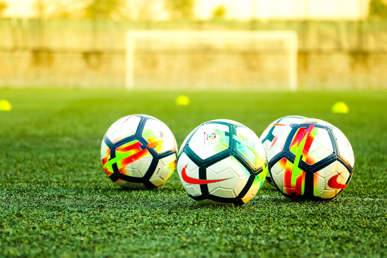 Match balls lined up on a club training pitch